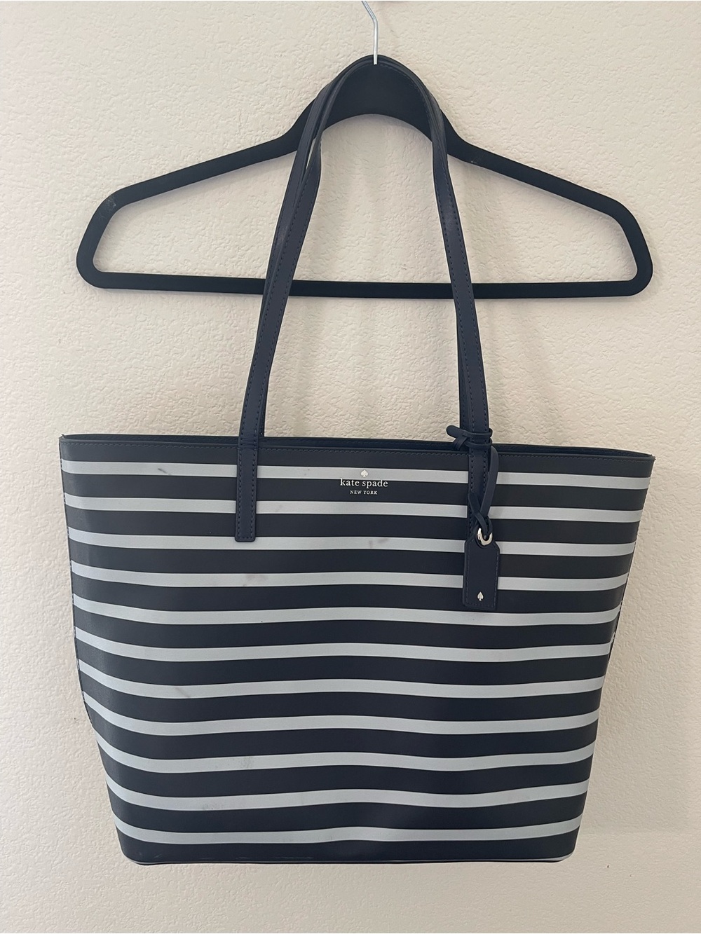 Kate Spade Navy blue and white striped tote with tag charm